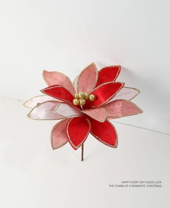 Close-up of fabric Christmas Poinsettia with gold glitter edges and center beads