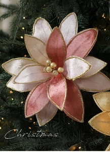 Close-up of pink and beige fabric poinsettia with gold glitter edges on a Christmas tree
