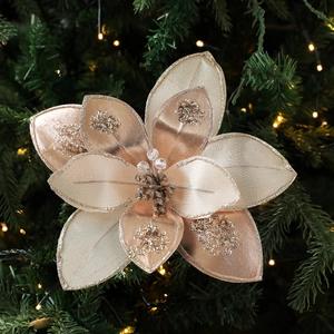 Champagne gold fabric poinsettia with sequins on a decorated Christmas tree