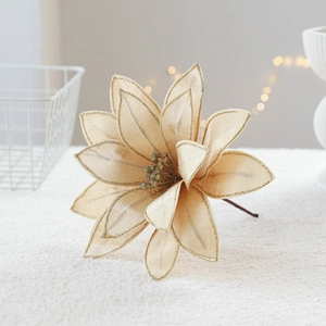 Champagne gold artificial Christmas poinsettia flower with glitter edges in cozy decor