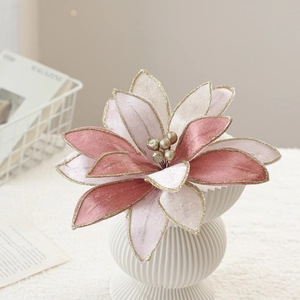 Pink velvet poinsettia Christmas flower with gold glitter edges in a white vase