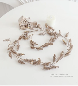 Champagne gold Christmas pine needle garland with glitter finish on white background