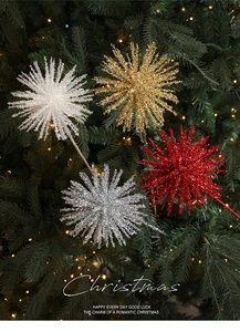 Sparkling starburst Christmas ornaments in gold and silver on a festive Xmas tree