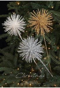 Detail of glittered starburst flower picks in gold and silver on a Christmas tree