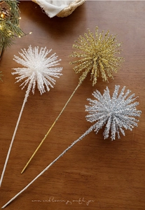 Detail of colorful glitter star picks for Christmas tree decoration on a wooden background