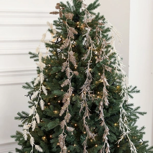 Champagne gold glitter artificial leaves vine branches hanging on a festive Christmas tree