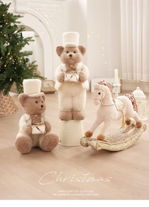 Detail of plush Christmas bear dolls and beige rocking horse with festive gold sequins