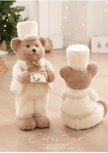 Detail of plush Christmas bears with drum and gold trim in festive holiday setting