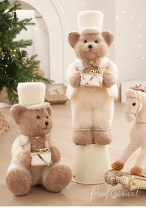 Detail of plush Christmas bears in beige formal wear with drum and sequined rocking horse