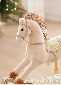 Close-up of plush rocking horse ornament with gold sequins, floral saddle and tassels