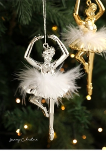 Detailed view of ballet girl Christmas ornaments with white feathers on a festive tree