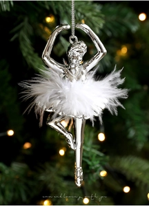 Detail of silver ballet girl ornament with soft white feathers on a Christmas tree