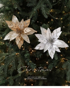 Close-up of gold and silver poinsettia decorations with sequins on a Christmas tree