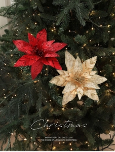 Close-up of sparkling 28cm glitter fabric poinsettia flowers on a Christmas tree