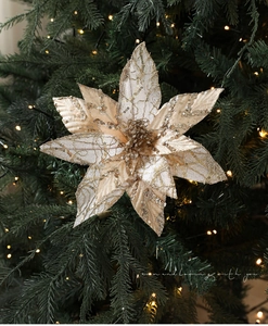 Macro view of a 28cm champagne gold poinsettia flower with sequins on a Christmas tree