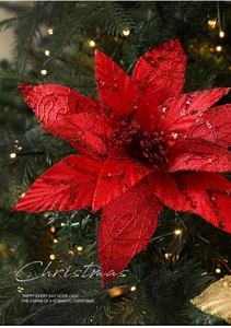 Close-up of red glitter poinsettia flower petals on a decorated Christmas tree
