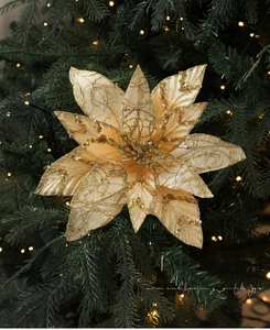 Close-up of golden 28cm glitter mesh Christmas poinsettia flower on a festive tree branch