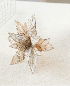 Macro shot of 28cm beige and gold glitter poinsettia flower for Christmas tree decor