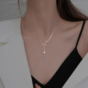 Close-up of rose gold Big Dipper necklace featuring delicate star pendants on a model