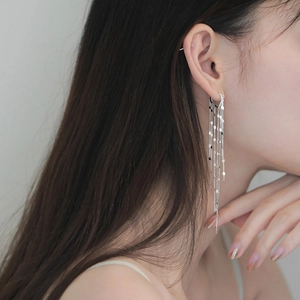 Silver heart-shaped stud earrings featuring long metal chain tassels and polished round discs