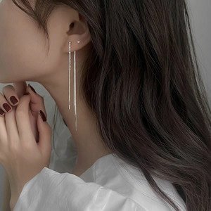 Close-up of elegant S925 silver long tassel earrings with sparkling zircon on a model