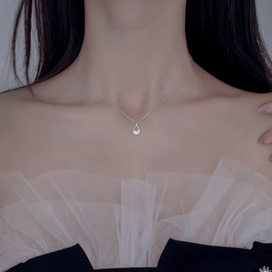 Detailed view of teardrop zircon pendant on S925 silver chain worn by a female model