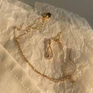 Detail of S925 sterling silver stamp on golden water drop zircon pendant necklace
