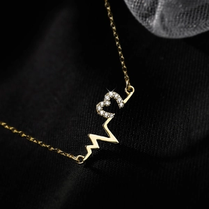 Macro shot of 925 silver heartbeat necklace with sparkling pavé cubic zirconia