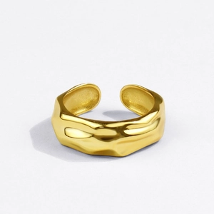 Close-up of golden adjustable ring with irregular wave texture and hammered finish