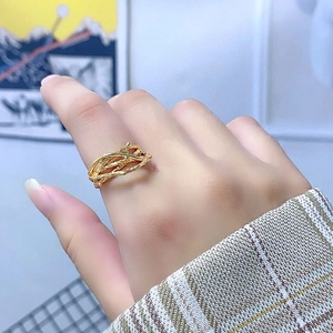 Detailed view of irregular golden thorn ring worn on finger with artistic branch design