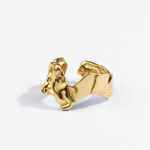 Detailed close-up of golden irregular lava design ring with fluid metallic texture