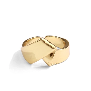 Detailed view of adjustable golden ring with polished irregular geometric twisted design