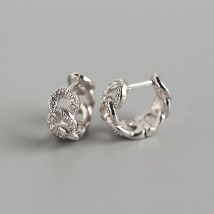 Macro shot of silver S925 chain link hoop earrings with micro-pave zircon crystals