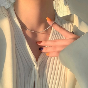 Close-up of sparkling S925 sterling silver snake chain necklace on a model's collarbone