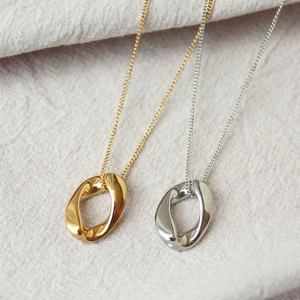 Minimalist irregular oval pendant necklace in polished gold and silver finishes