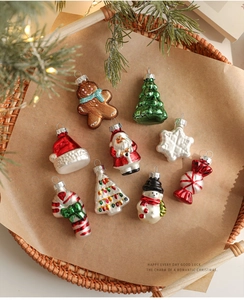 Detailed view of nine festive Christmas glass ornaments arranged in a woven basket