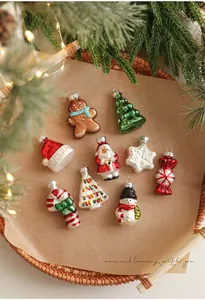 Exquisite handmade glass Christmas ornaments with glitter details on a woven tray