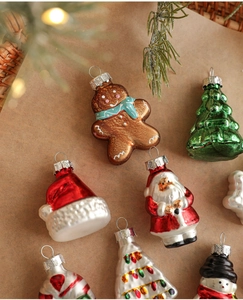 Close-up of assorted glass Christmas ornaments including gingerbread man and snowman