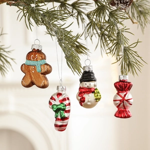 Set of 4 Christmas glass ornaments including gingerbread man and snowman on pine branches