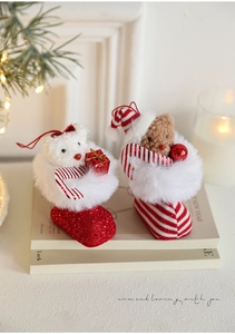 Detail of Christmas plush bears in glittery boots on a warm festive background