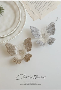 Detail of translucent glitter butterfly ornaments with hanging strings for Christmas decor