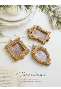 Close-up of golden vintage baroque mini photo frames with ornate floral embossing