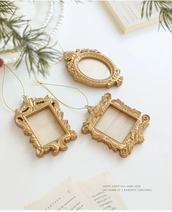 Close-up of golden baroque mini photo frames with intricate vintage relief patterns