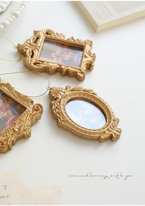 Three-piece set of mini baroque gold picture frames with ornate floral relief and hanging cords