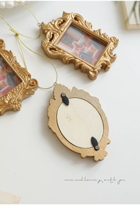 Three-piece set of ornate vintage gold frames with intricate carvings and golden hanging cords