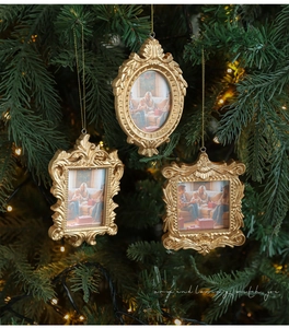 Vintage gold baroque mini photo frame ornaments hanging on a Christmas tree with warm lights