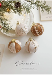 Detailed view of brown and beige Christmas baubles with gold embroidery and sequins