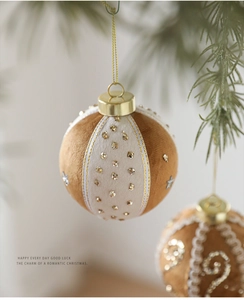 Close-up of 8cm brown velvet Christmas ball with gold sequins and luxury hanging string