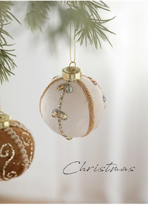 Macro view of 8cm velvet Christmas bauble with gold chains and rhinestone details