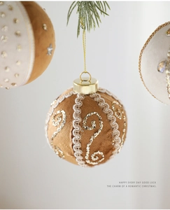 Close-up of 8cm brown Christmas ball with gold glitter swirls and lace texture decor